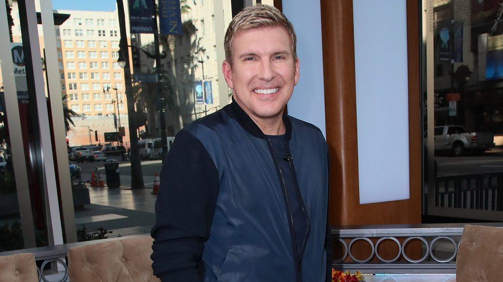 Todd Chrisley outside, in front of a building