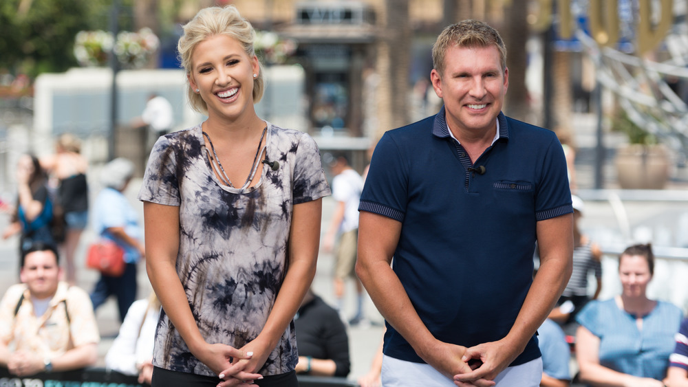 Todd and Savannah Chrisley in front of a crowd