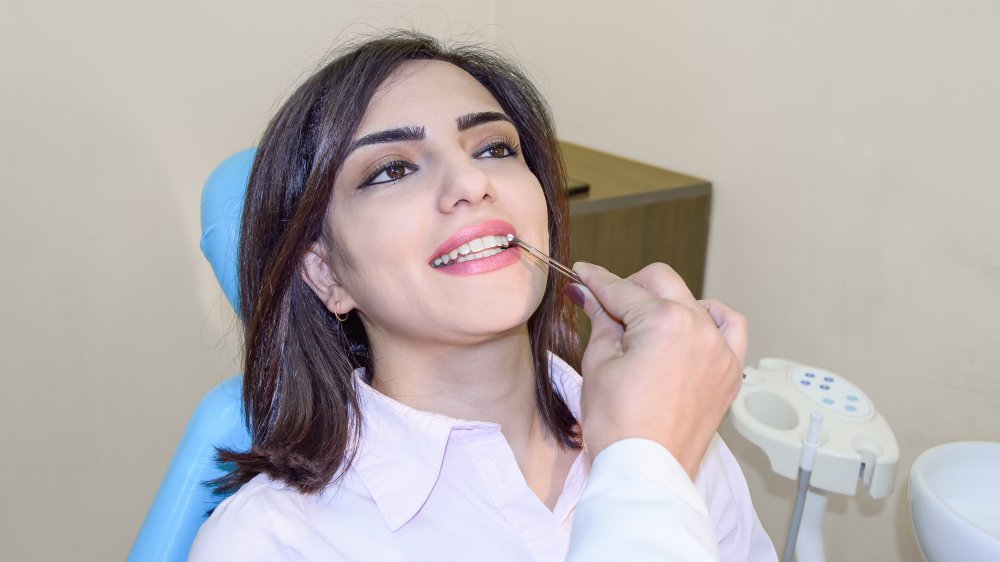 Dentist applying a tooth gem