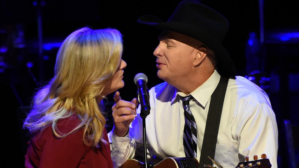 Trisha Yearwood and Garth Brooks perform onstage during The Country Music Hall of Fame at the Country Music Hall of Fame in 2015