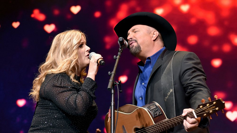 Trisha Yearwood and Garth Brooks perform onstage in 2019