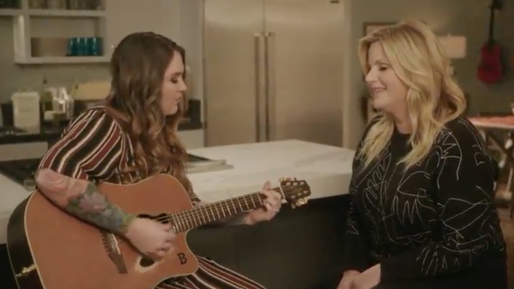 Trisha Yearwood and Allie Brooks playing the guitar