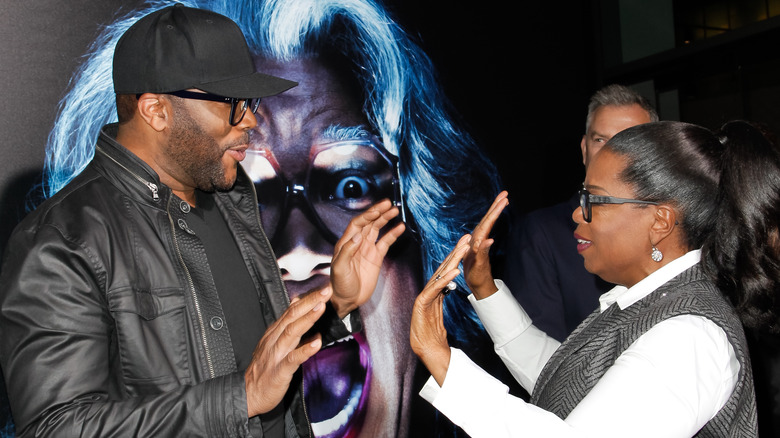 Tyler Perry and Oprah Winfrey high-five each other