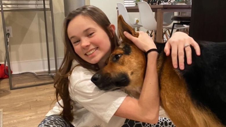 Mariah Bell hugging a dog