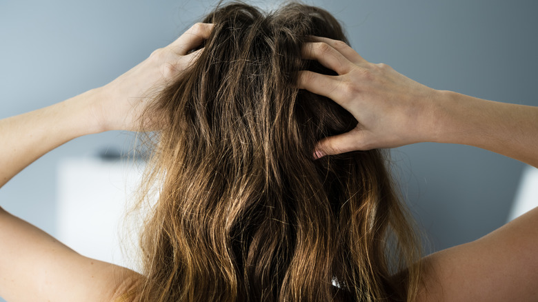 Woman styles her hair