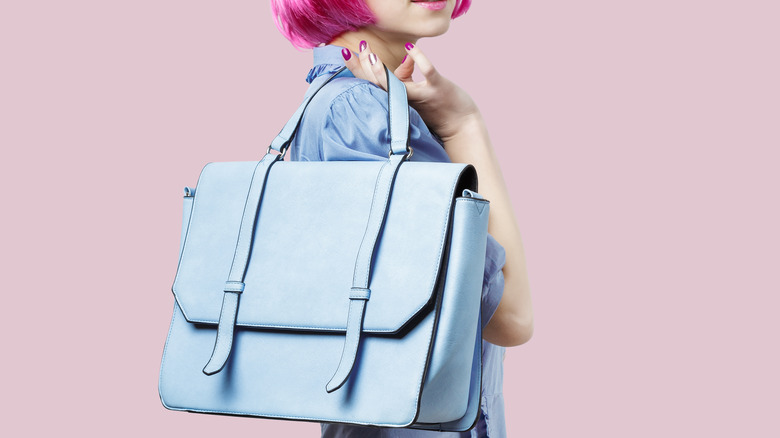 woman holding blue bag 