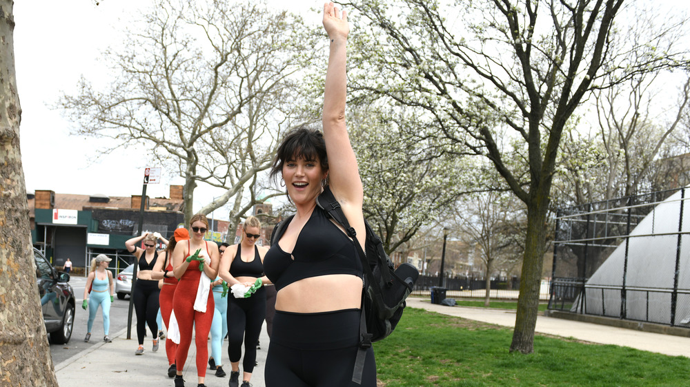 Ali Tate-Cutler in sports bra hand up