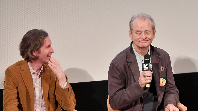 Bill Murray with mic beside Wes Anderson