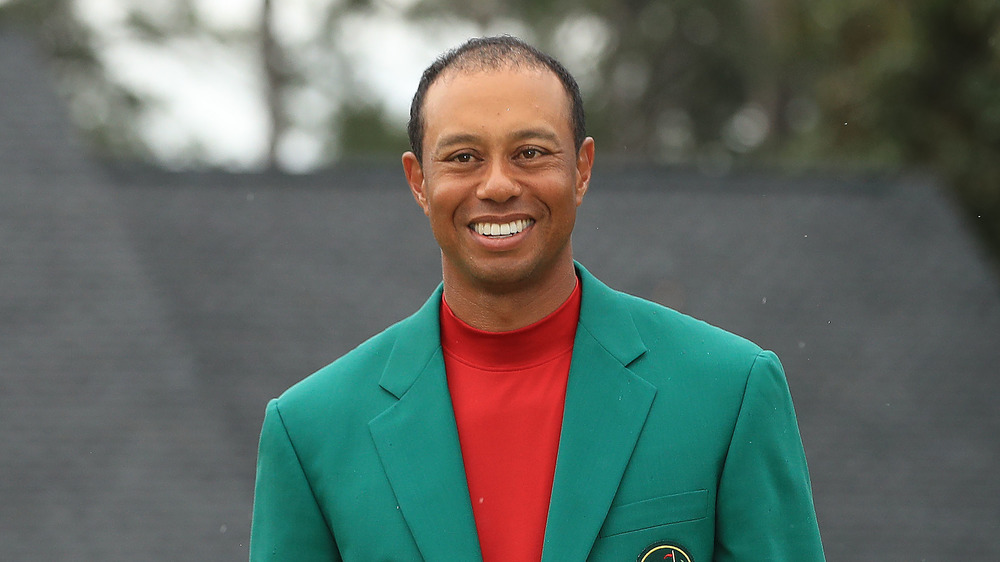 Tiger Woods smiling in Masters green blazer