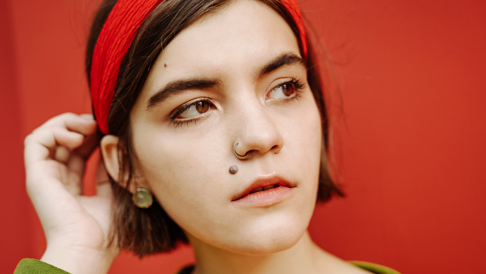 Woman with a beauty mark wearing a red headband