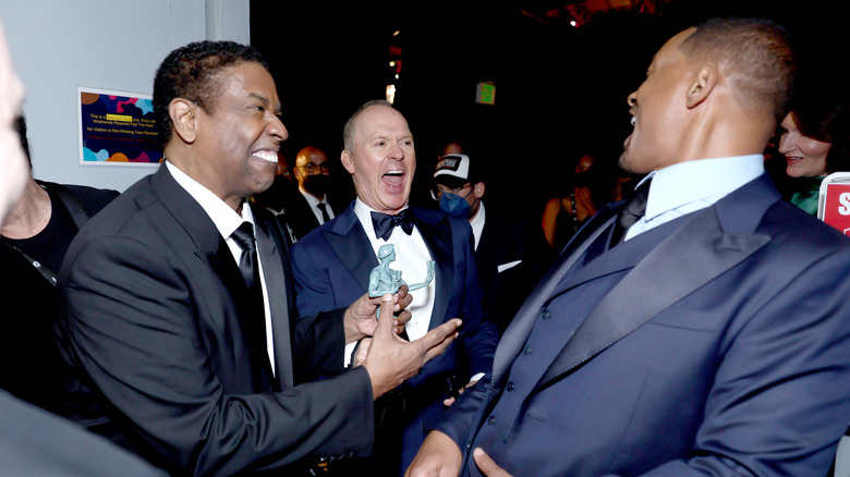 Denzel Washington, Michael Keaton, and Will Smith exchanging laughter