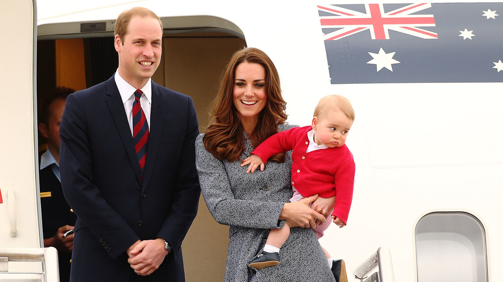 Prince William, Kate Middleton, and Prince George stepping off a plane