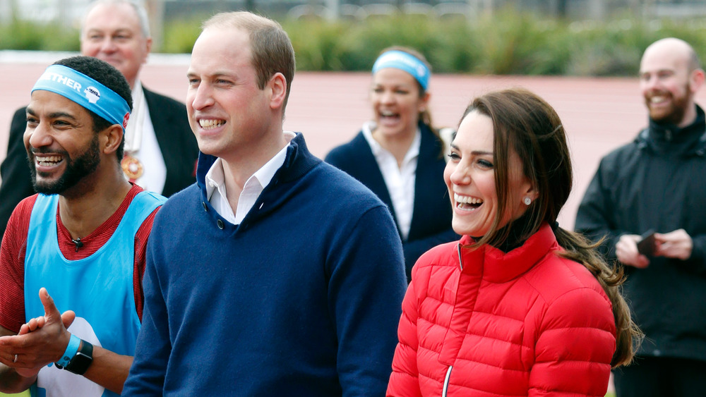 Prince William and Kate Middleton outside at a sporting event