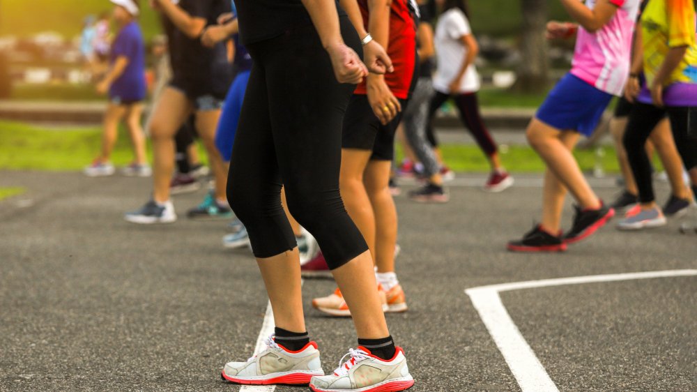 large group exercising on basketball court