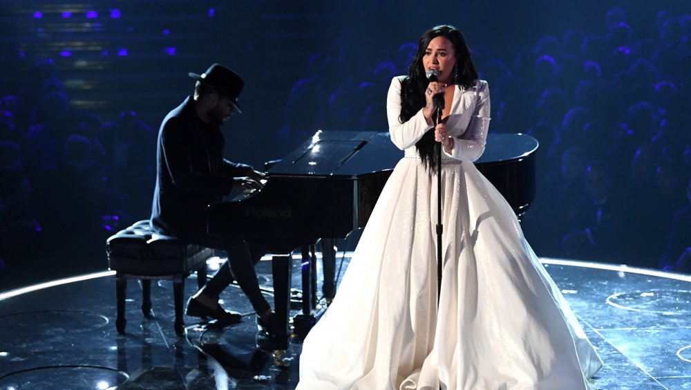 Demi Lovato performing at the 2020 Grammy awards with her pianist