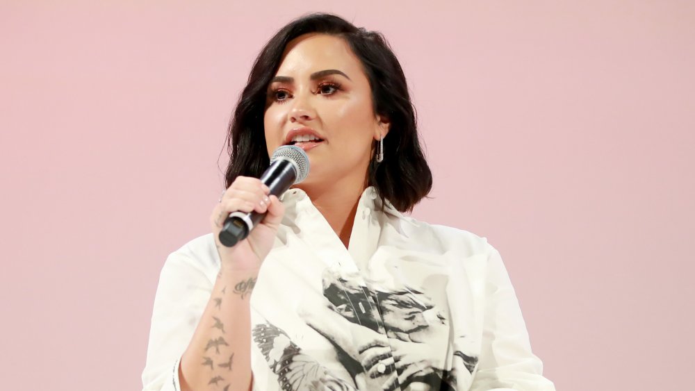 Demi Lovato speaking at a Teen Vogue summit in 2019