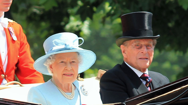 Prince Philip and Queen Elizabeth riding in carriage