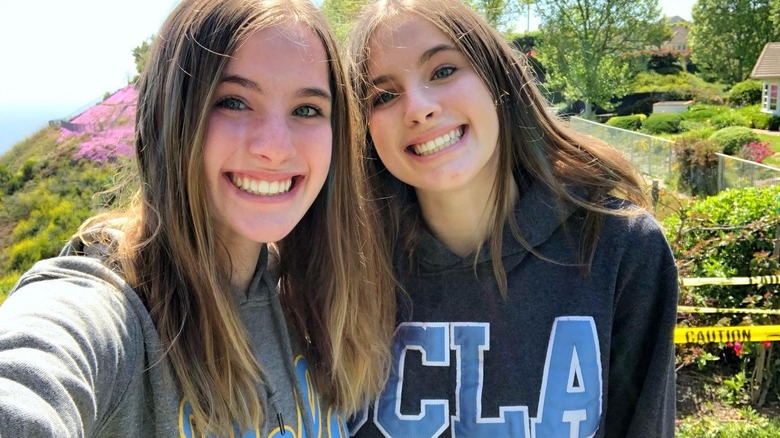 Cali and Noelle Sheldon in university sweatshirts