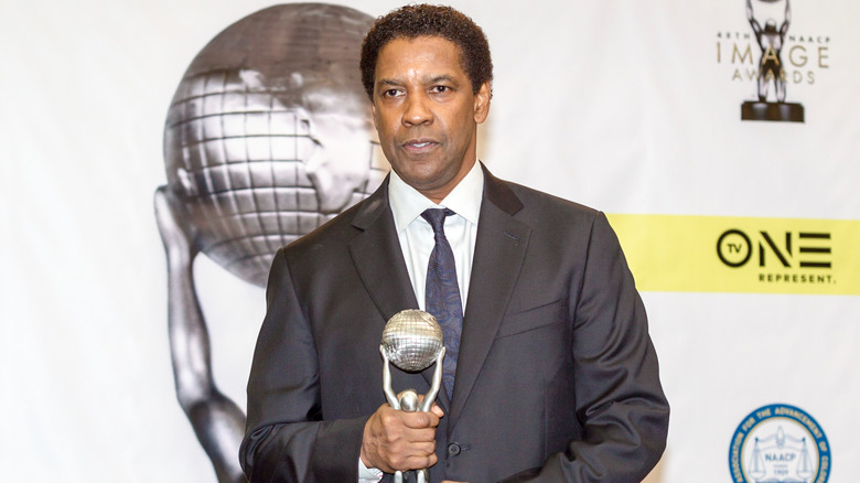 Actor Denzel Washington poses with statue at the 48th NAACP IMAGE AWARDS