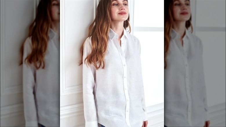 Model wearing white button down linen shirt