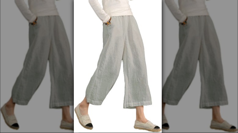 Model wearing wide leg grey pants