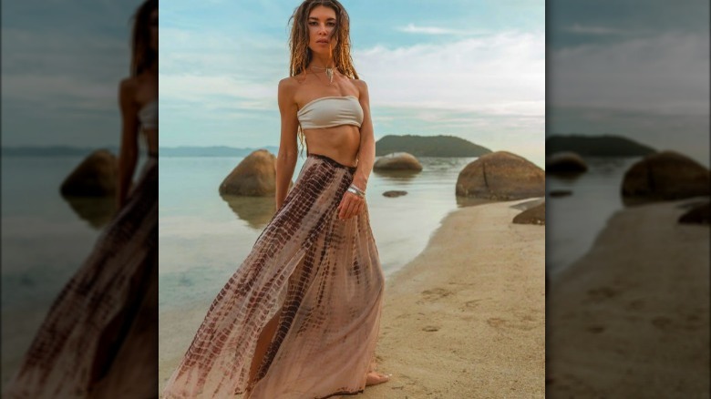Model wearing light brown maxi skirt on the beach
