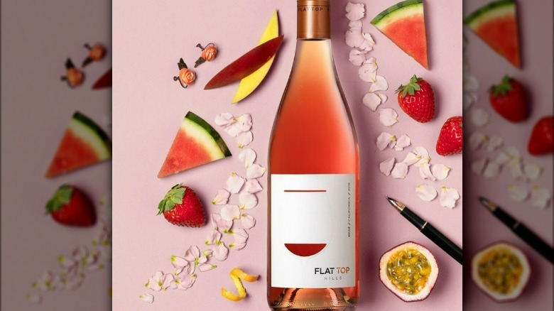 Bottle of pink rosé wine with strawberries and fruit