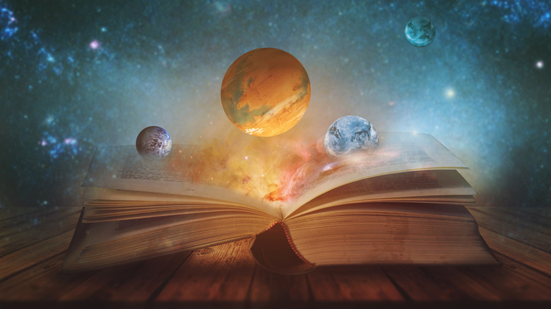 A book with stars and planets coming out of it 