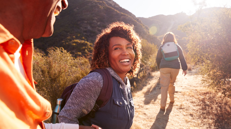 People smiling while hiking 