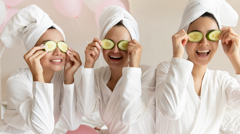 Three woman with cucumbers on their eyes at a spa 