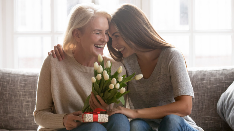 An older and younger woman exchanging gifts 