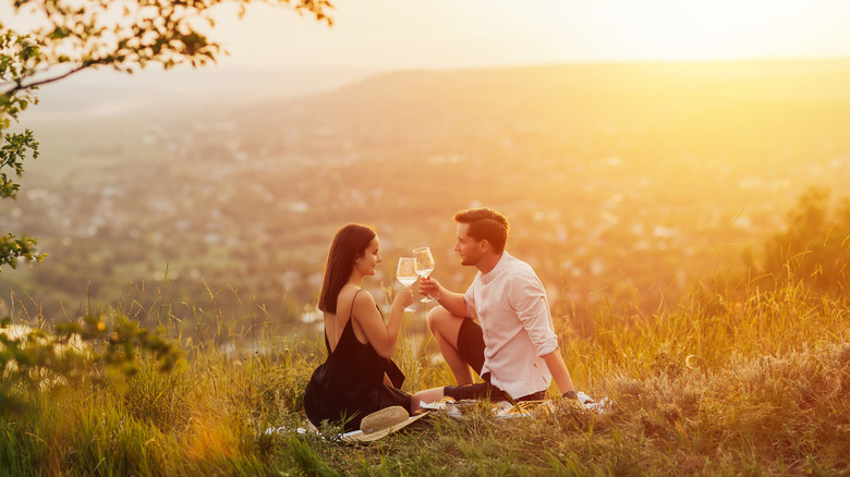 Two people enjoying a glass of wine outdoors 