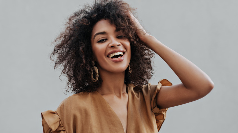 Woman with curly hair laughing