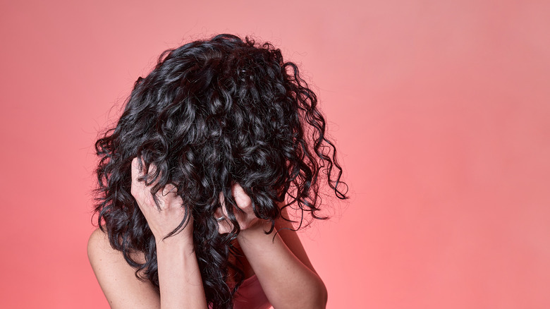 Woman scrunching her curls