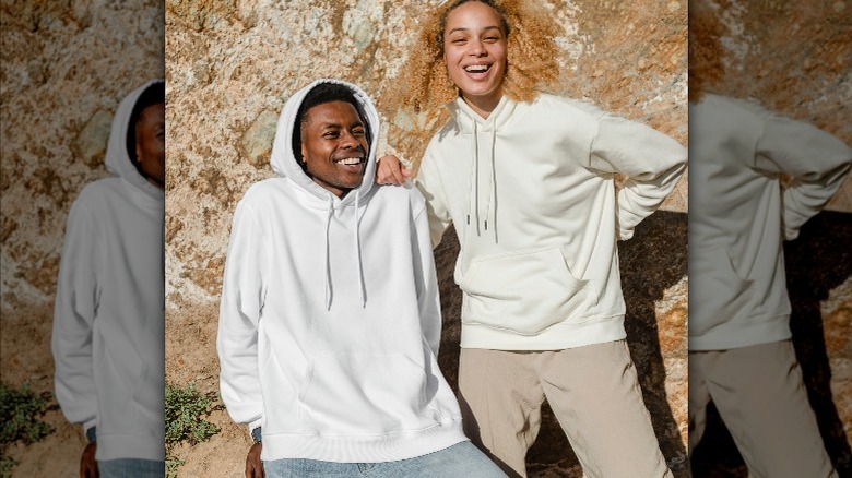 Smiling people in white hoodies