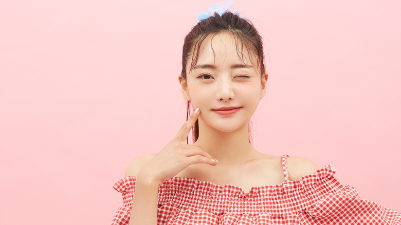 Girl with red gingham top and ponytail