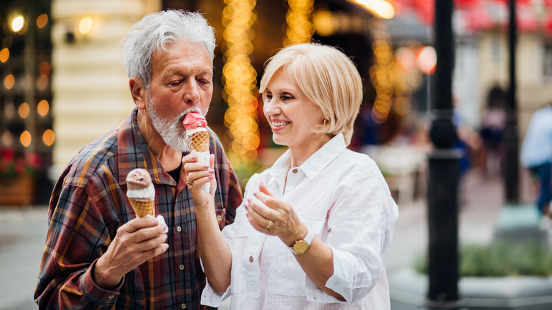 Older couple eating ice cream cones