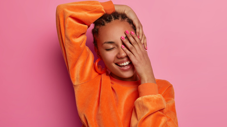 Woman with cornrows smiling