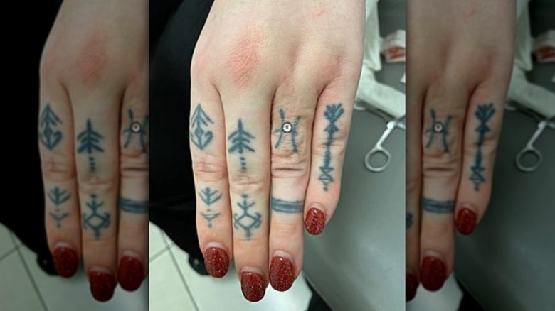 Hand with dermal piercing on finger