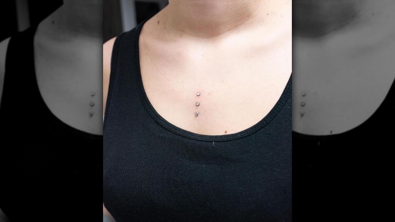 Person with three dermal piercings on chest