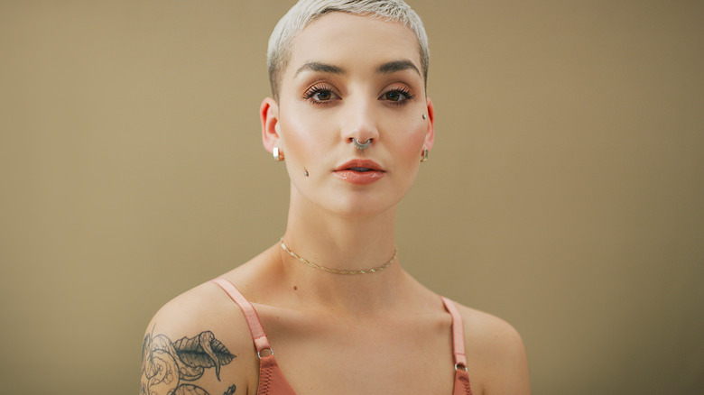 Woman with two facial dermal piercings
