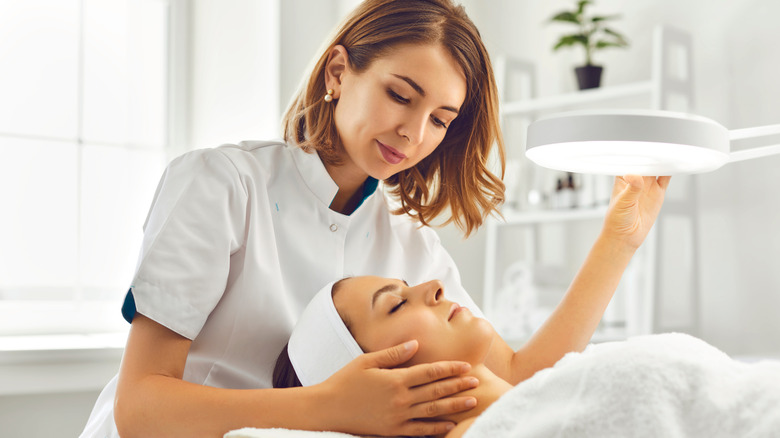 Woman getting a brightening facial