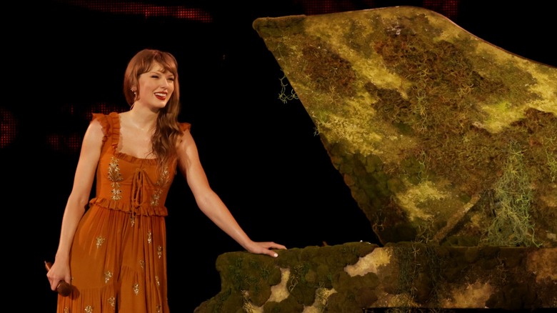 Taylor Swift smiling at a piano