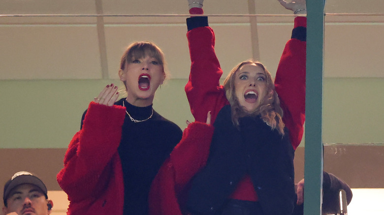 Taylor Swift and Brittany Mahomes cheering in luxury suite