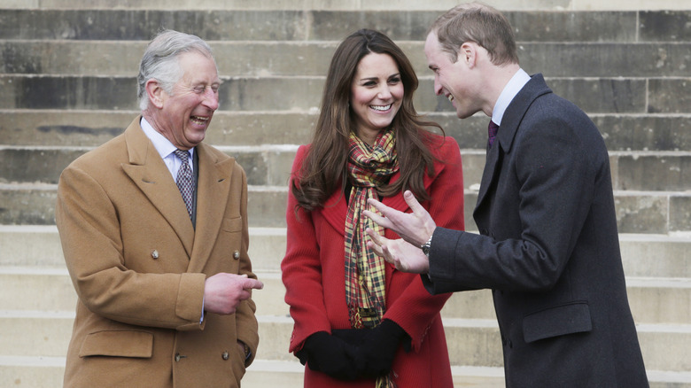 King Charles III, Kate, and William chatting, laughing
