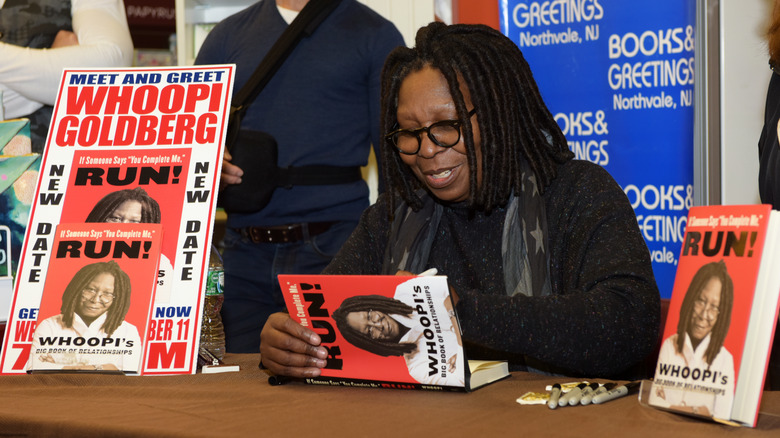 The author signs a copy of her book 