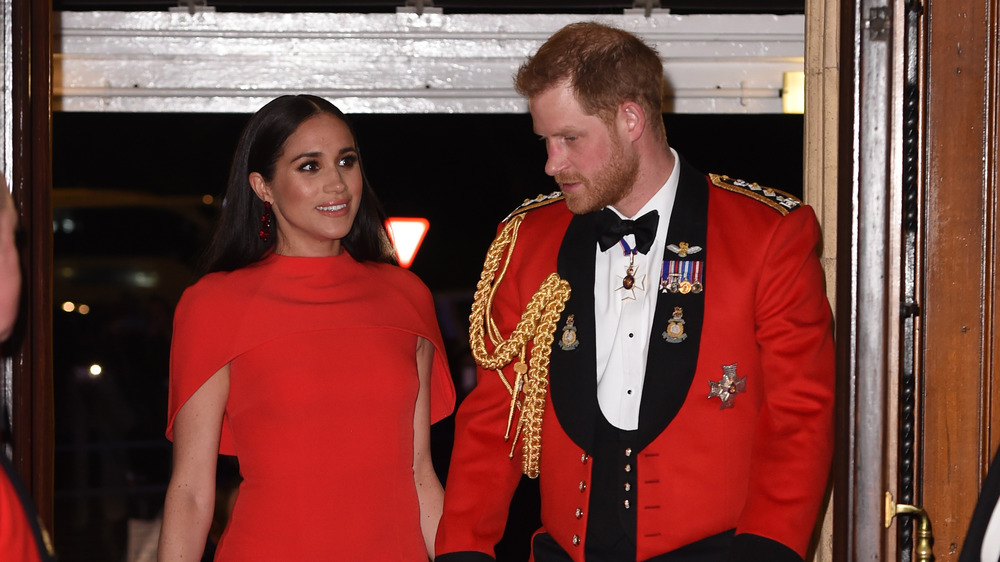 Prince Harry and Meghan Markle wearing red