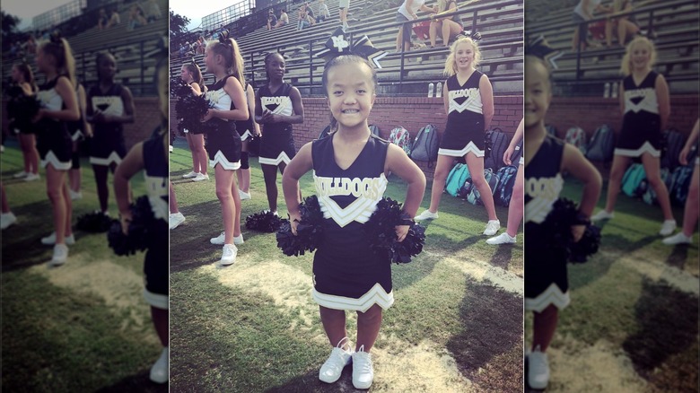 Emma Johnston poses in her cheerleading uniform