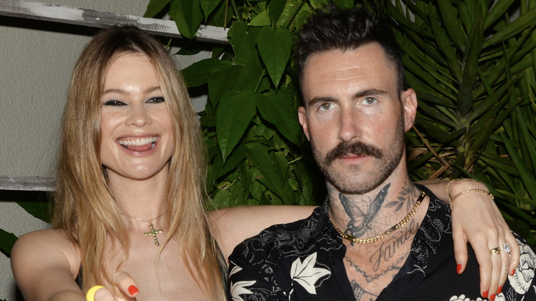 Behati Prinsloo and Adam Levine at the Calirosa Tequila Sunset Happy Hour at South Beach Wine & Food Festival on February 24th, 2022 in Miami Beach, Florida