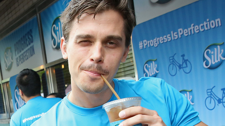 Antoni Porowski with a drink